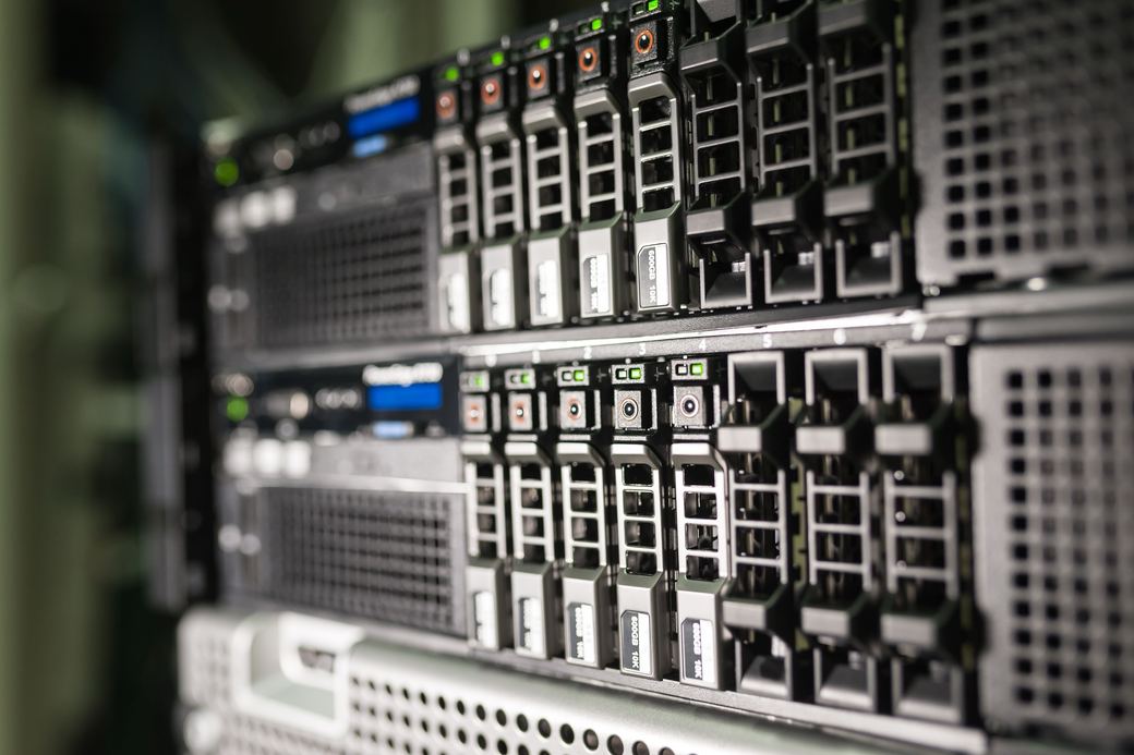 Rack servers with rows of drive bays and green status lights